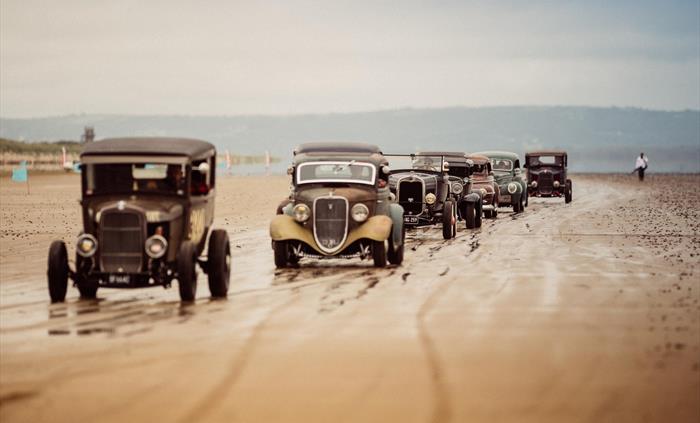Vintage Hot Rod Association cars lined up on Pendine Sands. They visit Pendine and the Museum of Land Speed every June.